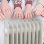 family-warming-up-to-radiator